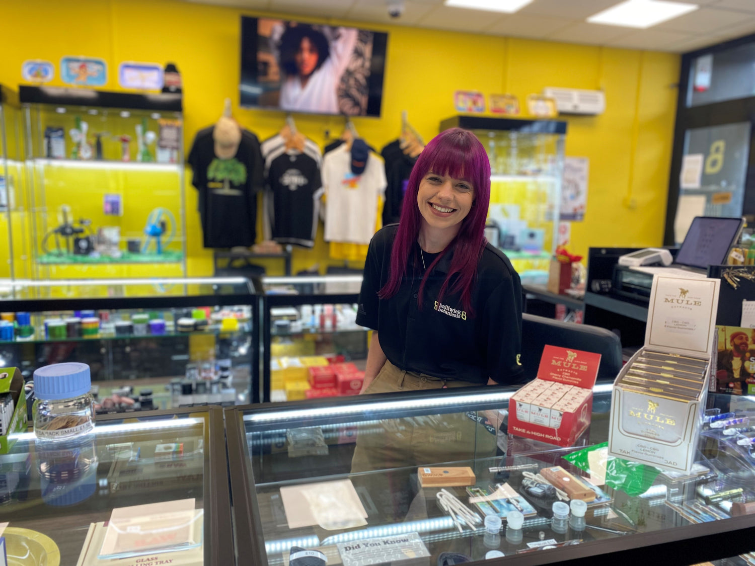 Happy female shop assistant, here to help you find the right product